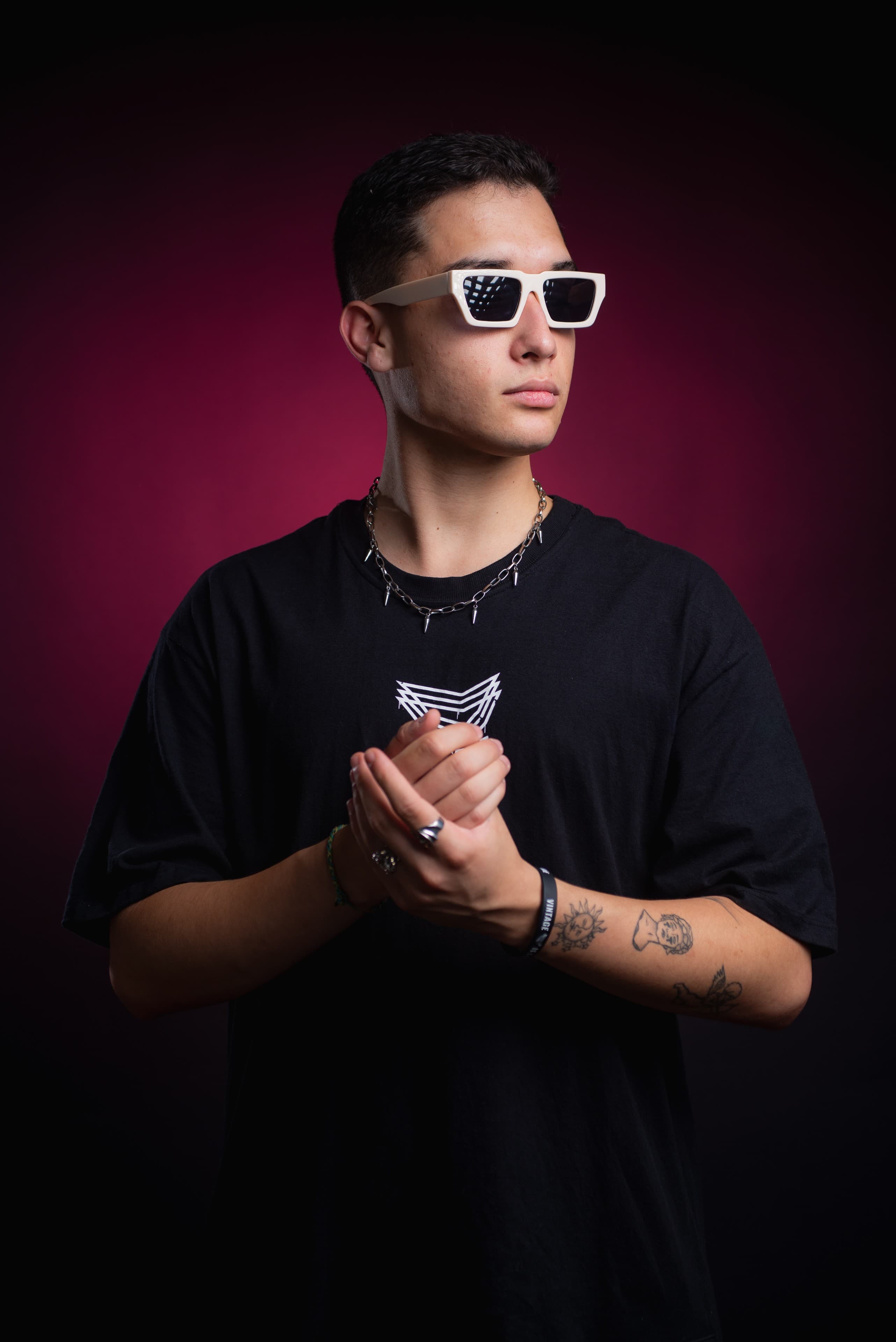 DJ Rubens em retrato com fundo magenta